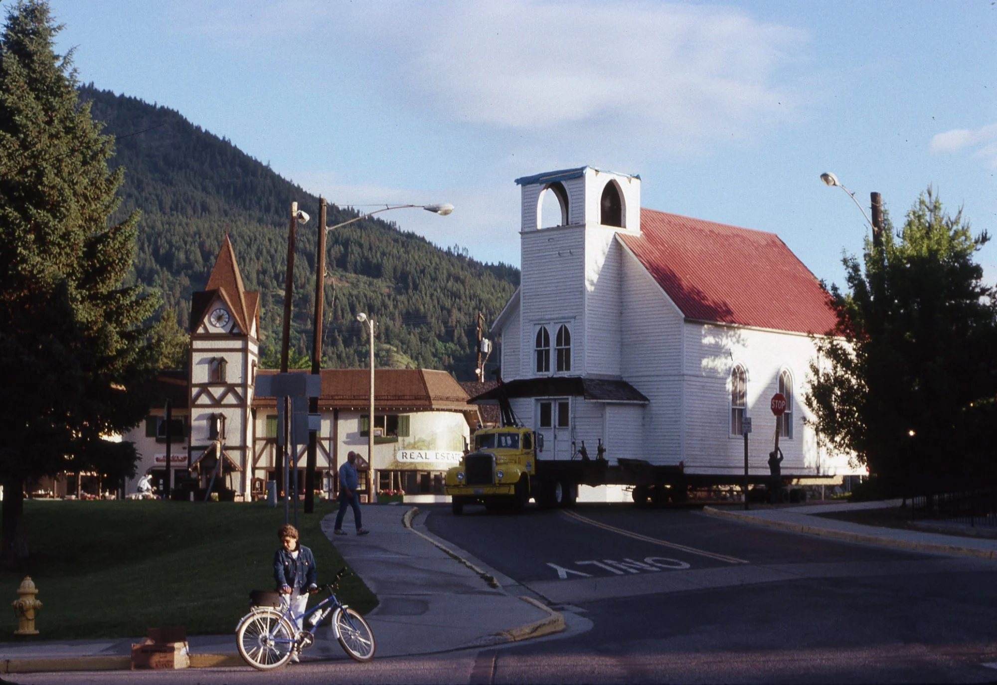 The chapel on a flatbed truck passing through downtown Leavenworth, the Bavarian clock tower visible in the background